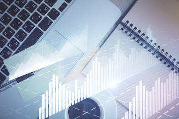 Stock market graph and top view computer on the table background. Double exposure. Concept of financial education.