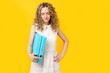 © Dzmitry - A young woman holds folders with documents in her hands.