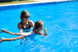 © Philipp Berezhnoy - mom teaches her daughter to swim in the pool
