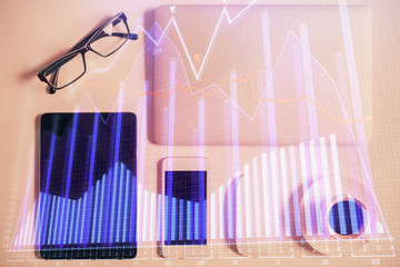 Multi exposure of financial chart hologram over desktop with phone. Top view. Mobile trade platform concept.