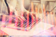 © peshkova - Multi exposure of woman hands typing on computer and financial graph hologram drawing. Stock market analysis concept.