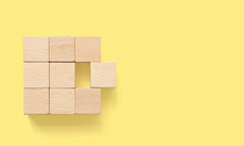 Group Of Wooden Cube Block On Yellow Background With Copy Space