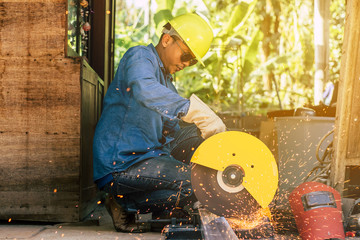 A technician is cutting steel on a construction site.