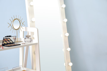 Poster - Table with decorative cosmetics and mirror in modern makeup room