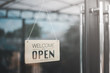 © Looker_Studio - 'Open' on cafe or restaurant hang on door at entrance.