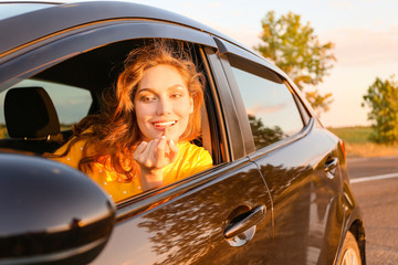 Wall Mural - Young woman doing makeup while sitting in car