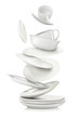 Set of clean dishes and cups in flight on white background