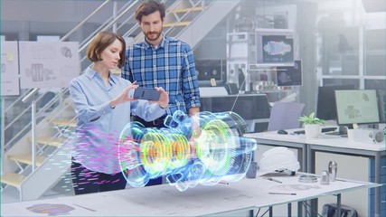 Wall Mural - industry 4.0 facility: female designer with chief engineer use smartphone with augmented reality app