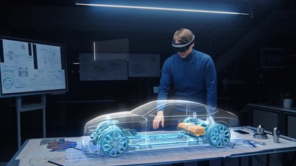 Leinwandbilder - Automotive Engineer Wearing VR Headset Working on 3D Electric Car Design, Using Gestures in Augmented Reality He Designs and Manipulates Graphical Parts, Picks Body for the Chassis and Engine