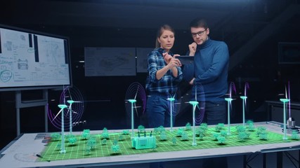 Wall Mural - renewable energy engineers design 3d wind turbine park using augmented reality hologram and smartpho