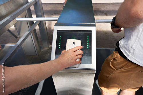Cuadros en Lienzo Pass through turnstiles with smartphone