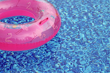 Pink Rubber Ring In The Pool Close-up. Summer Concept.