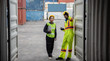 © May Chanikran - Young worker team with laptop at container terminal port warehouse for check stock product.
