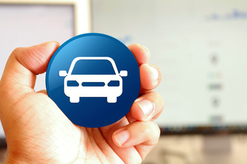 Wall Mural - Car icon blue round button holding by hand infront of workspace background