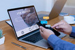 © RoBird - Job search concept, find your career, Person hand using laptop and smartphone typing into job searching.