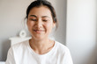© Drobot Dean - Close up of a smiling young asian woman relaxing