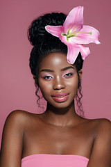 Wall Mural - pink make up. beauty fashion portrait of young beautiful african american model with bunned hairstyl
