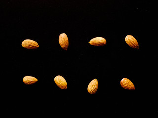 Wall Mural - Almonds isolated red background, nut beans