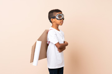 Poster - African American boy  with aviator hat and with wings with his arms crossed over isolated background