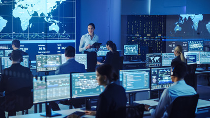 team of professional computer data science engineers work on desktops with screens showing charts, g