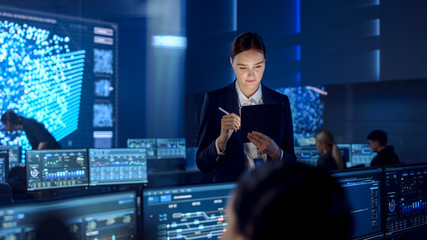 Poster - Female Project Leader is Standing with Tablet Computer and Checking Work Data. Science Engineers Work Around Her. Telecommunications Control Monitoring Room with Neural Network on Big Screen.