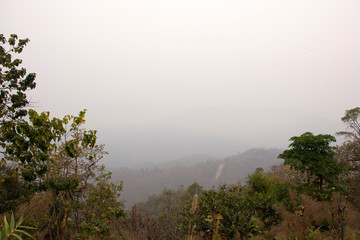 View landscape mountain and forest nation park with mist or fog at viewpoint of Doi Kiew Lom Scenic Point in Pang Ma Pha hill valley village city while PM 2.5 Dust situation at Mae Hong Son, Thailand