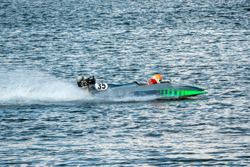 Powerboat with number 35 go fast along the lake