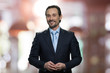 © DenisProduction.com - Smiling mature businessman looking at camera. Handsome man in business suit on abstract blurred background.
