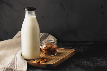 Almond milk with almond nuts in glass