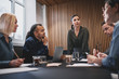 © Flamingo Images - Young businesswoman talking with colleagues during a boardroom m
