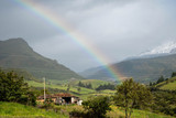 Fototapeta Tęcza - Beutiful natural landscape with a snowny mountain in the background with a amazing raimbow in the sky