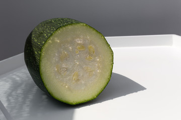 Ripe fresh green zucchini from the garden in summer on white table background