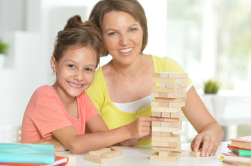 Poster - Portrait of little girl and her mother playing