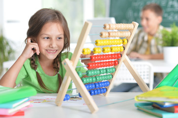 Poster - Cute little girl learning to use abacus