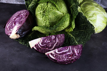 Wall Mural - Three fresh organic cabbage heads. Antioxidant balanced diet eating with red cabbage, white cabbage and savoy