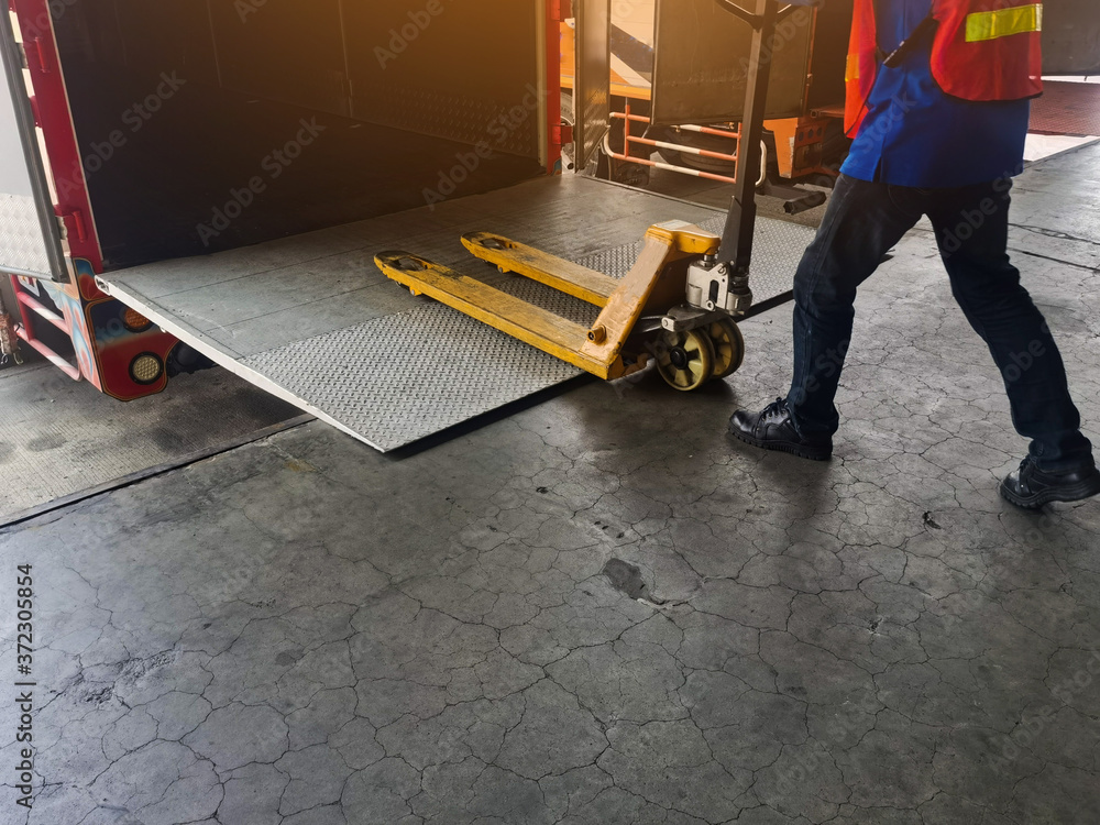 Worker driving forklift loading shipment carton boxes and goods on ...