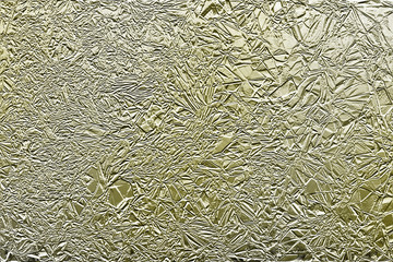 An abstract golden crushed foil texture background image.