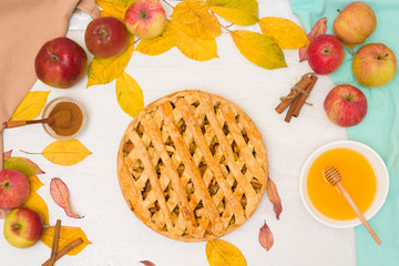 Wall Mural - Autumn baking concept. Cooking baking traditional autumn Apple pie, light background copy space. homemade sweet dessert with apples and cinnamon