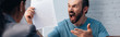 panoramic shot of angry and bearded man screaming while holding insurance policy agreement near lawyer