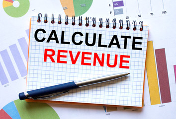 Notepad with text Calculate Revenue on business charts and pen