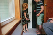 © Maria Manco/Stocksy - brother measure little sister on growth chart