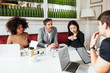 © Bonninstudio/Stocksy - Serious multiethnic managers listening to colleague