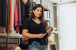 © kleberpicui - Latin woman owner of small business. Entrepreneurial woman working in her clothing store.