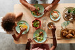 © Ivan Gener/Stocksy - Family eating dinner at home