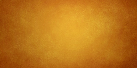 Canvas Print - orange golden brown abstract grunge background with light in the center and darkening at the edges