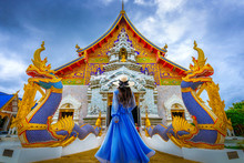 Asian Female Tourist Wearing A Blue Dress Visits Khuakrae Temple In Chiang Rai, Thailand.