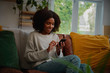 © StratfordProductions - Smiling girl relaxing at home using cellphone for texting and chatting with friends
