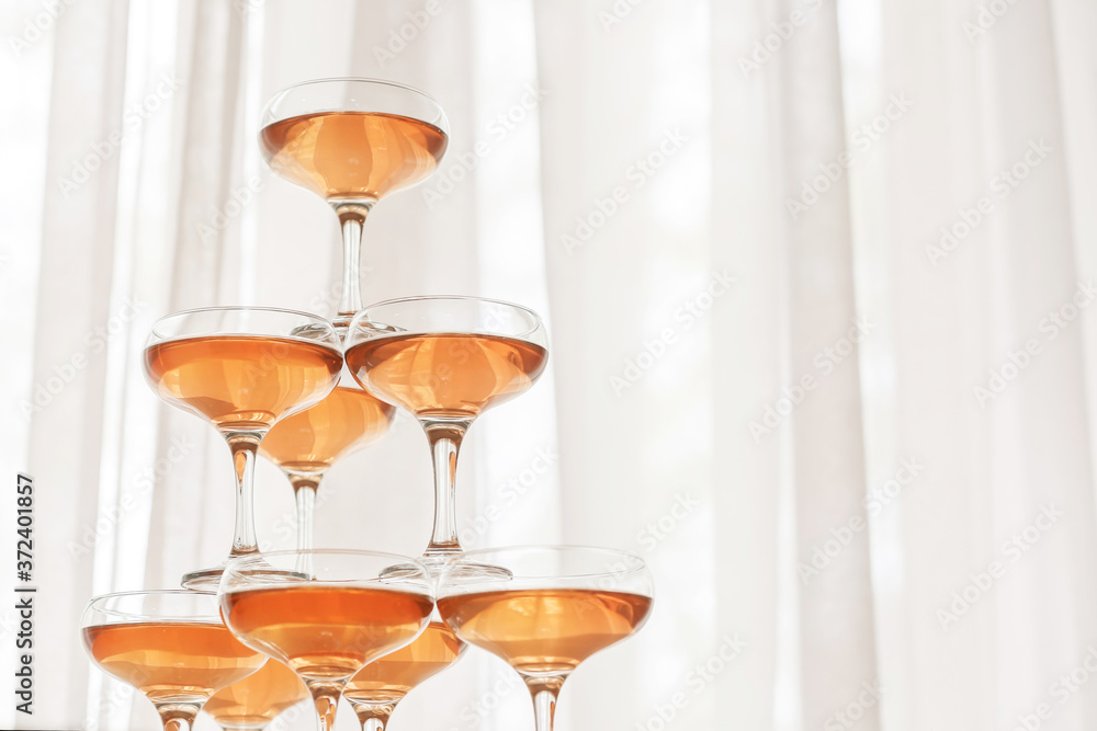 Tower made of glasses with champagne indoors