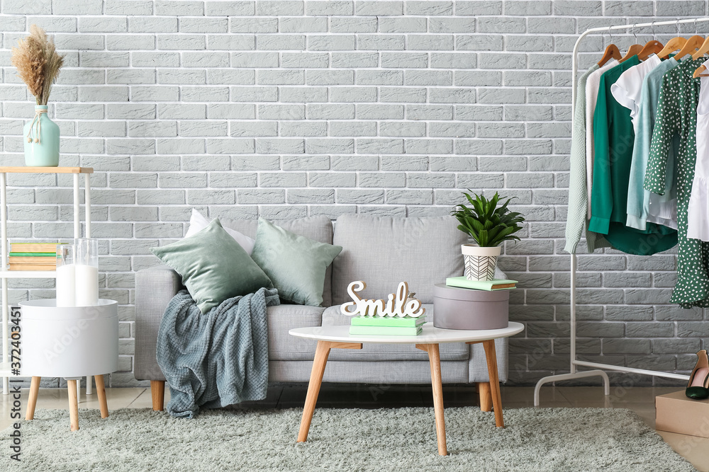 Stylish interior of living room with comfortable sofa and table