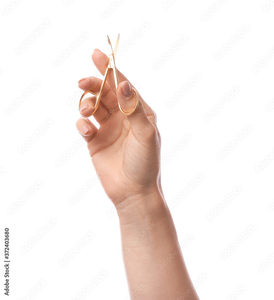 Female hand with manicure scissors on white background